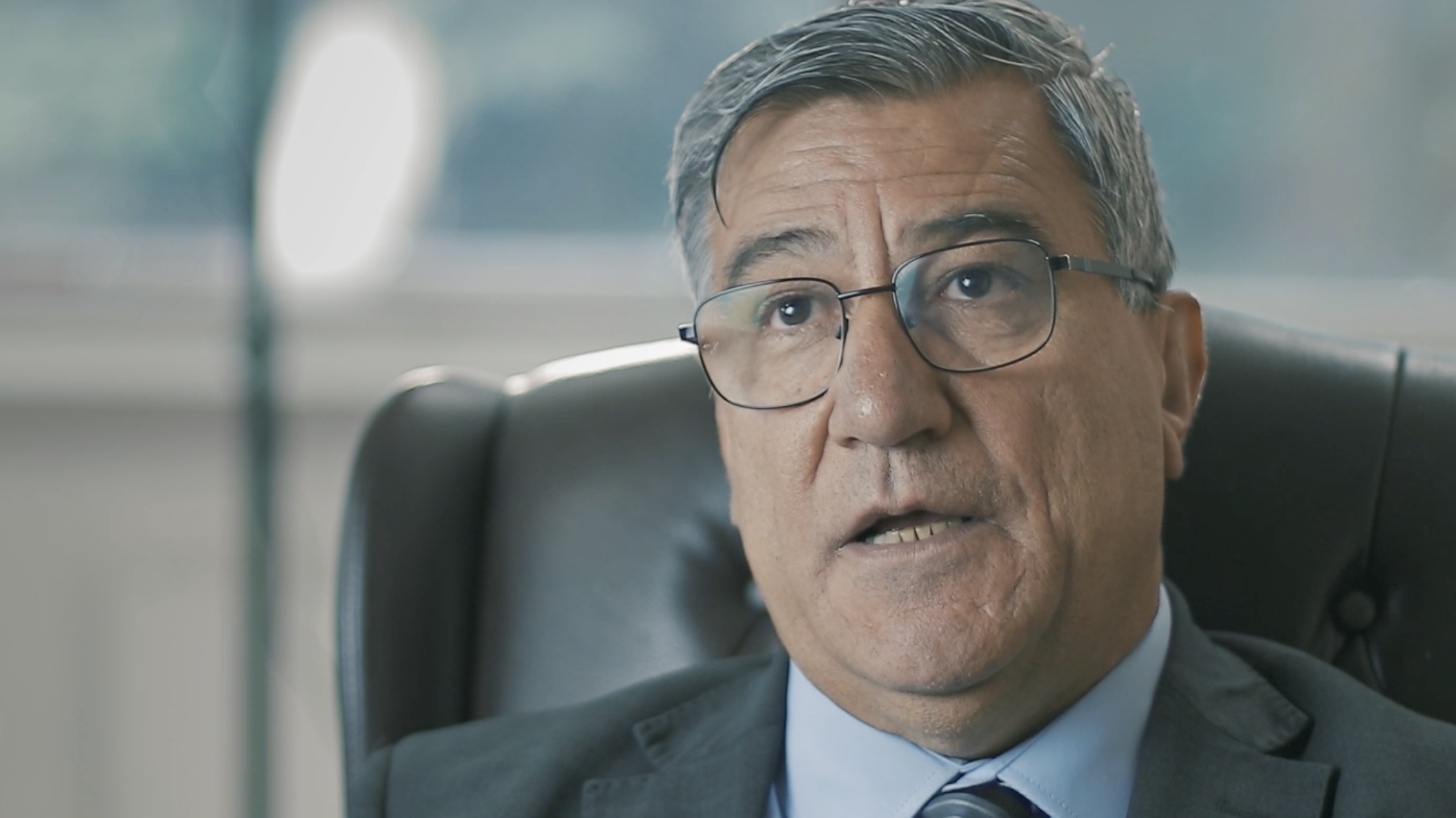 A man gives testimony in an interview setting